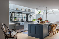 Island counter with bar stools in front of kitchen units