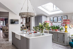 Downton chandelier above reconfigured kitchen with skylight window