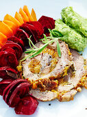 Roast pork with apricot and herb filling and dill and avocado cream