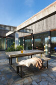 Table and bench combination on terrace with stone flags