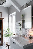 Washbasin below mirror in grey and white bathroom