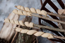 Bread dough for stick bread wound around twigs