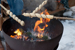 Toasting stick bread over an open fire