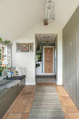 Hallway with floor-to-ceiling built-in cupboards and bench