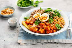 Quinoa bowl with sweet potatoes, chickpeas, spinach and boiled egg
