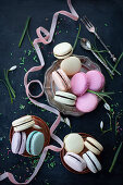 Assorted delectable macarons placed on pink table