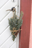 Spruce branches in chicken wire bags as door decoration