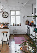 Open, whitewashed kitchen with terracotta tiled floor