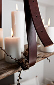 Leather strap holding DIY candle chandelier