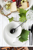 Set table decorated with vine leaves