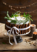 Midwinter Candle Cake dekoriert mit Kräutern, Zimtstangen und Schleifenband