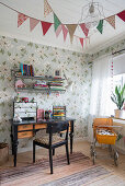 Old, black desk in vintage-style child's bedroom