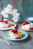 Star anise meringues with mango coulis and raspberries