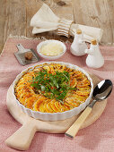 Sweet potato casserole with pecorino cheese and fresh rocket