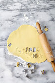 Rolled out shortcrust pastry with cut-out lettering