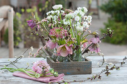 Small bouquets in wooden box: Ranunculus, Cuckoo flower Lychnis 'Petit Henri', lentil, beach lilac, and twigs