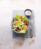 Smiley salad with potato circles, cucumber, tomatoes and feta
