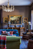 Leather armchairs and glass chandelier in library of 18th century mansion