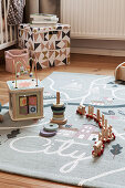 Wooden toys on play mat in child's bedroom
