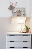 Table lamp on chest of drawers in child's bedroom