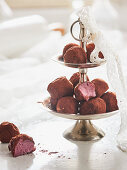 Raspberry truffles on a cake stand