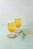 Beer punch with soda, peach liqueur and apricots