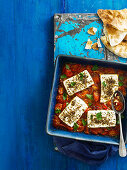 Baked feta with pomegranate and tomatoes