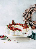 Festive pavlova wreath with local berries and pomegranate