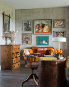 Leopard print chair at antique desk with framed artwork