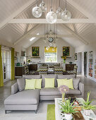 Open plan space with vintage glass globes grouped to define areas and botanical prints inspiring colour