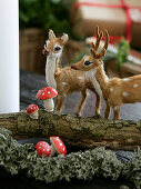 Christmas arrangement of branches, animal figures and small toadstools