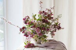 Spring bouquet of spring roses and branches of sloe and blood plum
