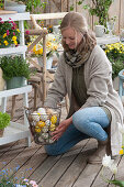 A woman holding a basket with Easter eggs