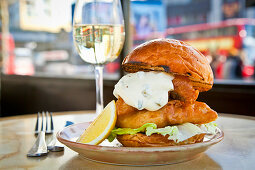 Battered fish in a brioche bun with lettuce and tartare sauce