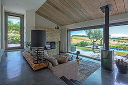 Open-plan interior with concrete floor and sliding glass door in split-level house