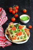 Savory waffles with cheese, herb pesto and tomatoes