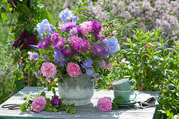 Early summer bouquet of roses, knapweeds, irises, scabious and lady's mantle