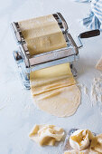Roll out pasta dough with a pasta machine