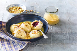 Blueberry dumplings with vanilla sauce and crumble