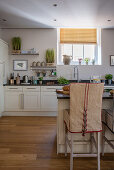 Chair cover in maritime nautical style at the kitchen island in an open kitchen