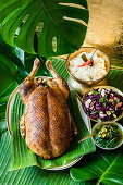 Duck cooked in banana leaves with hash brown rice and pointed cabbage salad
