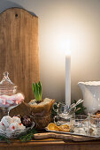 Candle burning on a rustic winter decorated buffet