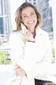 Joyful woman in white coat