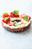 Breakfast bagel with feta and stewed tomatoes