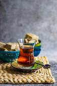 Turkish tea and dessert halva served in traditional style