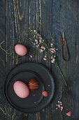 Easter eggs dyed with beets on a black plate