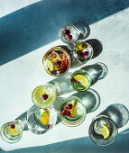 Glasses with lemonn and berry water on concrete background