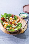 Potato caesar salad with eggs and bacon