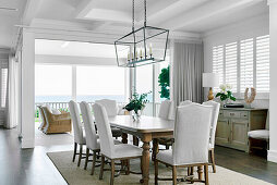 Elegant dining room with wooden table and upholstered chairs