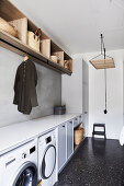 Washroom with fitted units, wooden shelving above